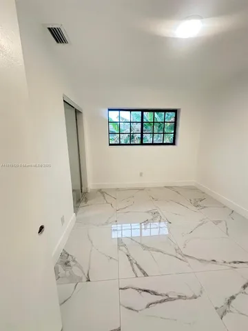 a view of a room that has a bed in it