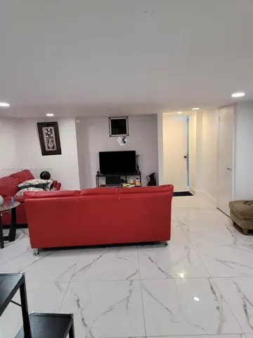 a bedroom with a bed and a lamp on the dresser