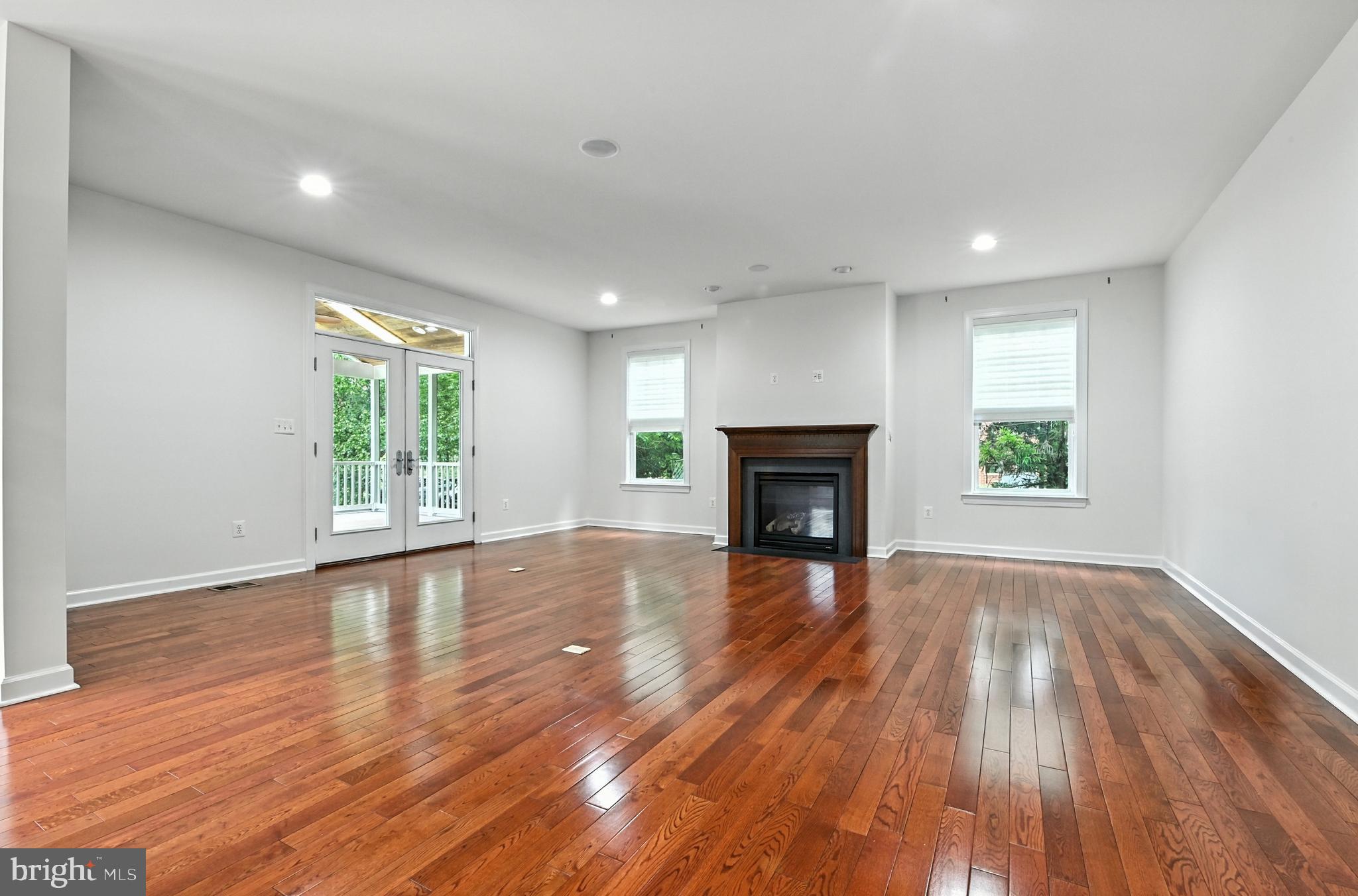 1901 Eamons Way Annapolis, MD 21401 - Photo 12 of 64 an empty room with wooden floor and fireplace