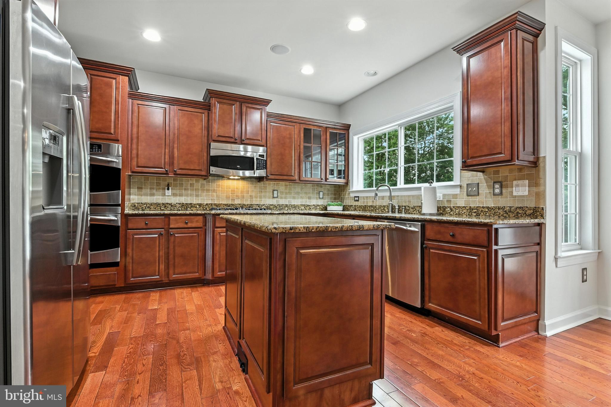 1901 Eamons Way Annapolis, MD 21401 - Photo 14 of 64 a kitchen with stainless steel appliances granite countertop wooden cabinets a sink and dishwasher a refrigerator with wooden floor