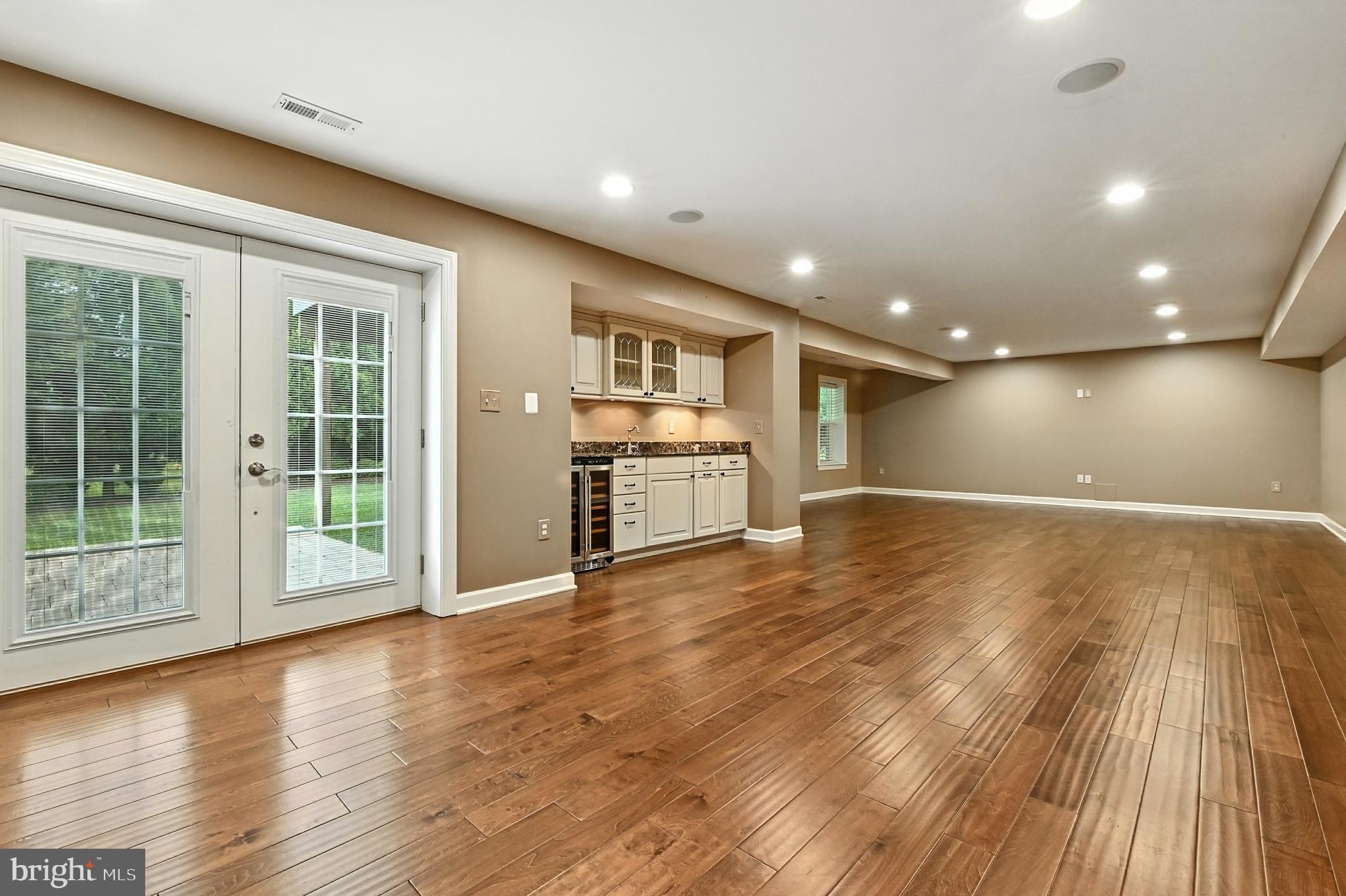 1901 Eamons Way Annapolis, MD 21401 - Photo 18 of 64 a view of an empty room with wooden floor and a kitchen