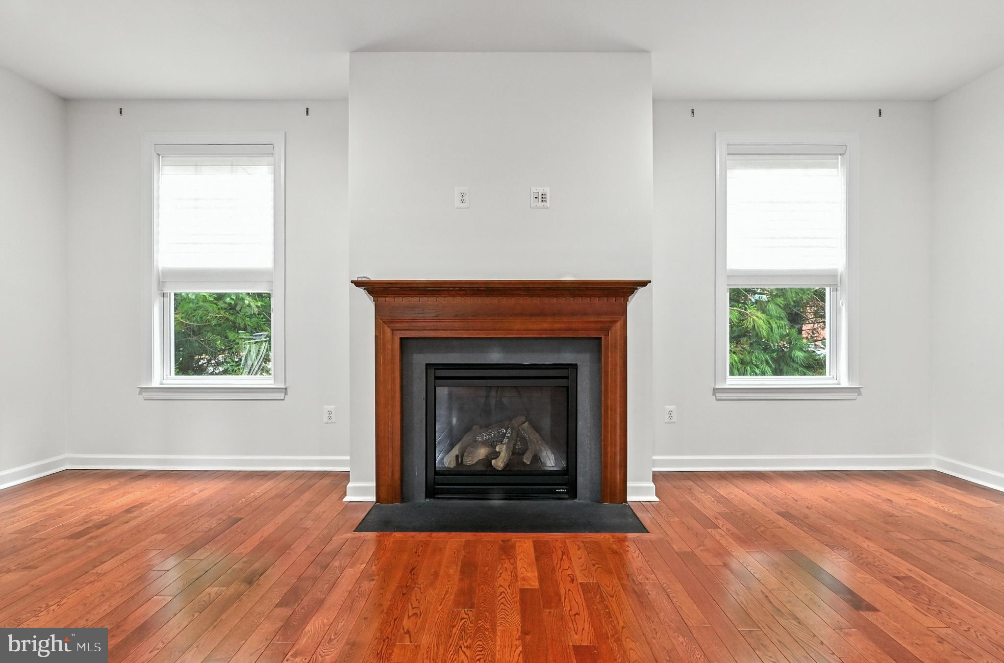 1901 Eamons Way Annapolis, MD 21401 - Photo 29 of 64 an empty room with wooden floor fireplace and windows