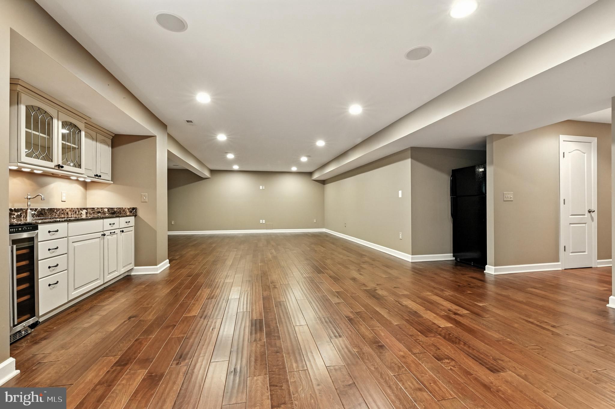 1901 Eamons Way Annapolis, MD 21401 - Photo 31 of 64 a view of an empty room with wooden floor and a kitchen