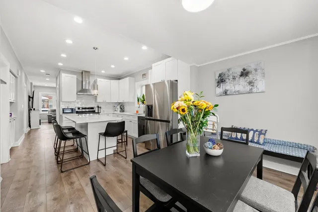 a view of a dining room with furniture and wooden floor