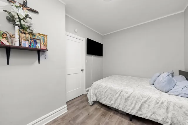 a bedroom with a bed and a tv