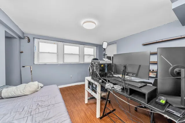 a bedroom with a bed and a desk