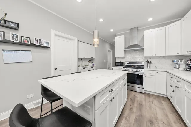a kitchen with kitchen island a stove a sink and a refrigerator