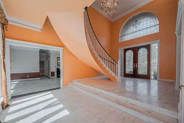 a view of a hallway with entryway wooden floor and front door