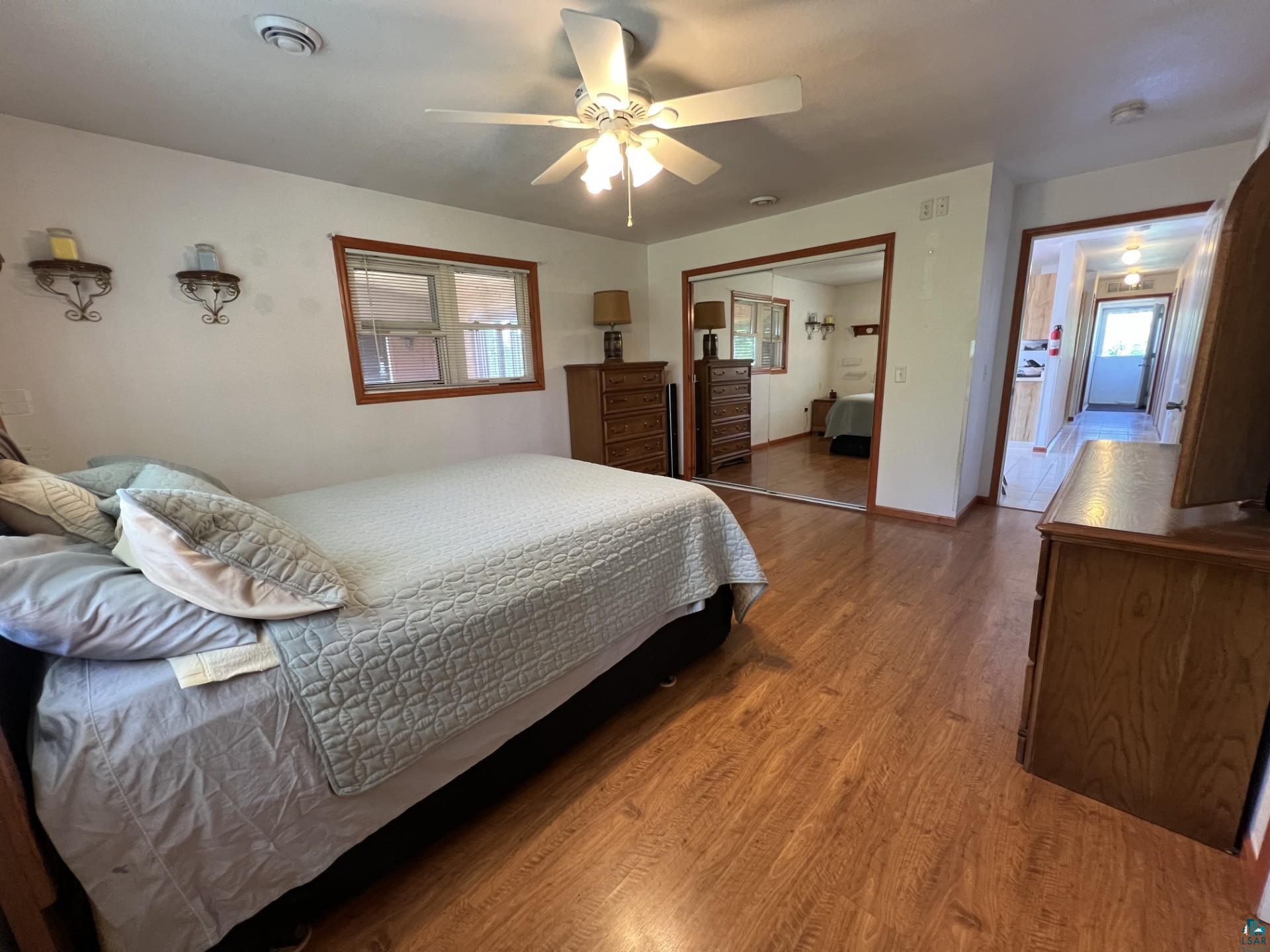 5144 Eagle Lake Road Duluth, MN 55803 - Photo 23 of 47 Bedroom featuring a closet, ceiling fan, and hardwood / wood-style floors