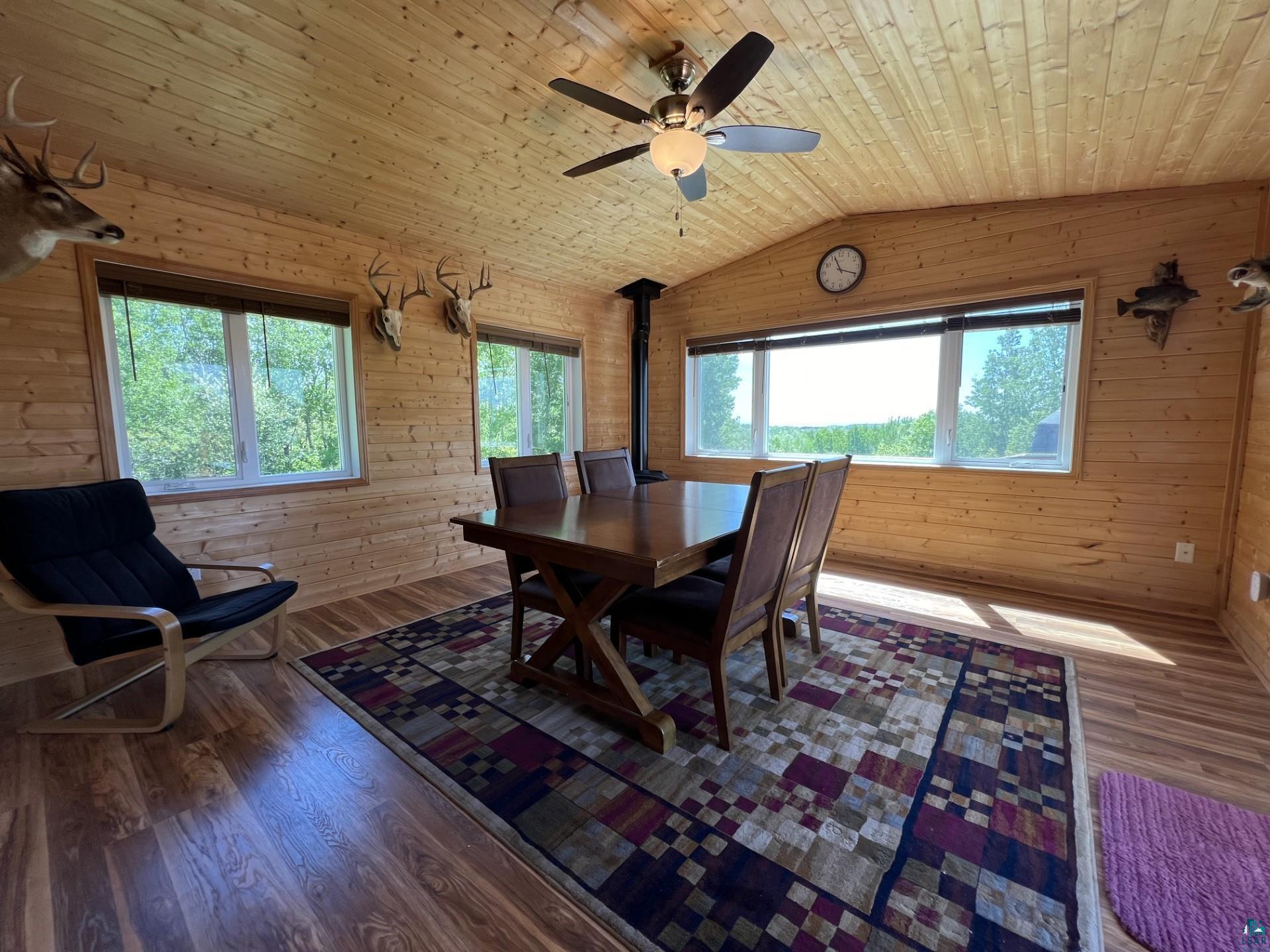 5144 Eagle Lake Road Duluth, MN 55803 - Photo 32 of 47 Dining room featuring wood ceiling, hardwood / wood-style flooring, wooden walls, and vaulted ceiling