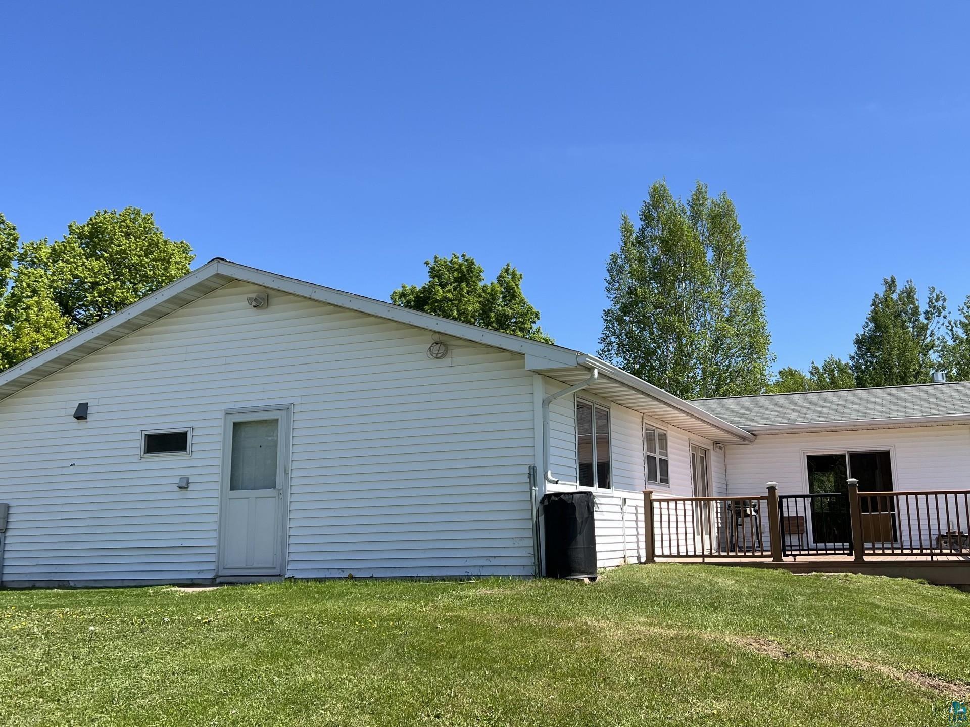 5144 Eagle Lake Road Duluth, MN 55803 - Photo 43 of 47 Rear view of house featuring a deck and a lawn
