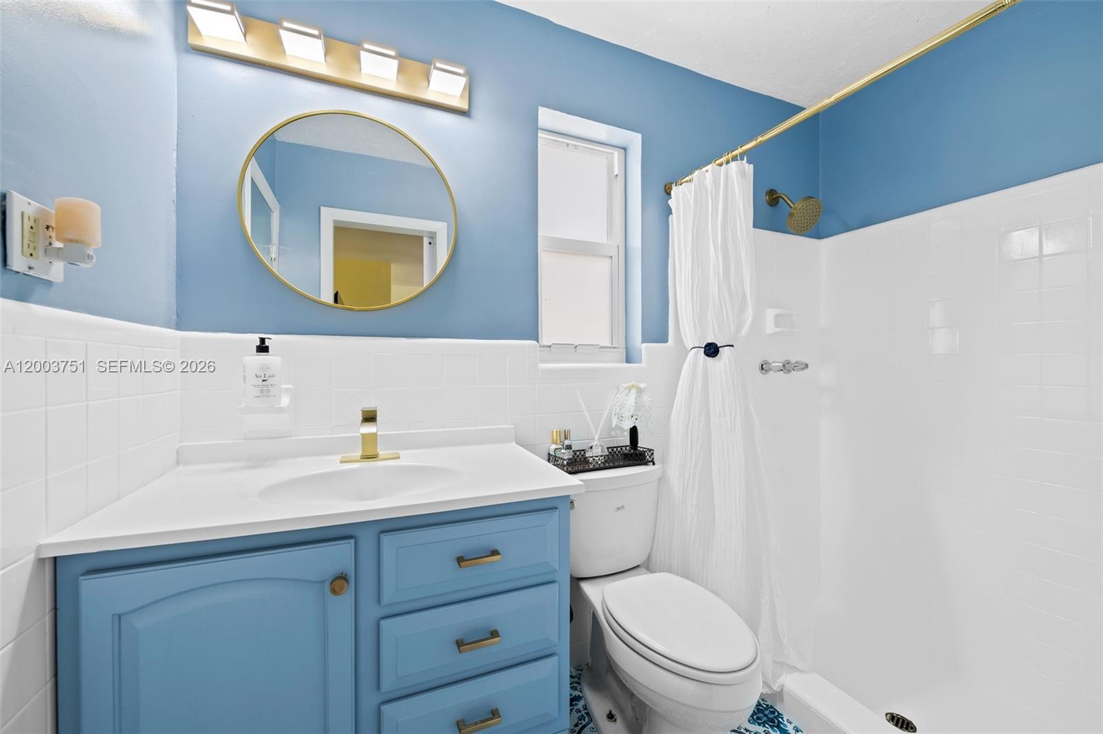 1925 North 39th Avenue Hollywood, FL 33021 - Photo 17 of 20 a bathroom with a toilet a sink a mirror and vanity