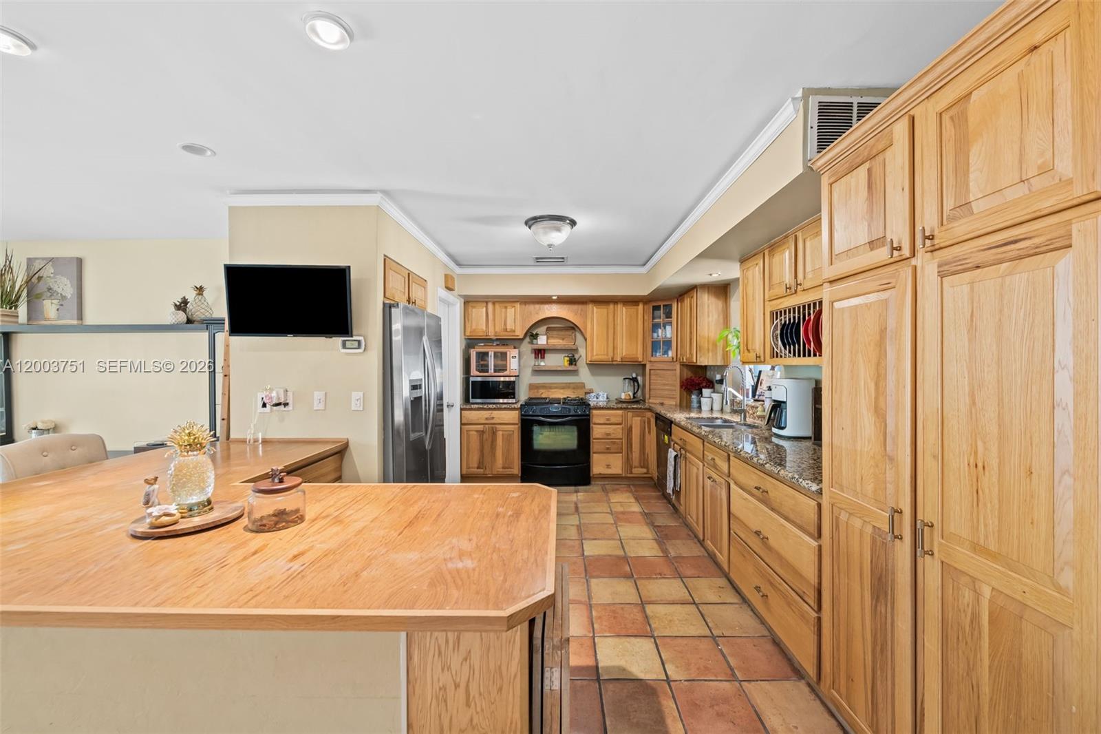 1925 North 39th Avenue Hollywood, FL 33021 - Photo 9 of 20 a kitchen with stainless steel appliances granite countertop a sink and cabinets