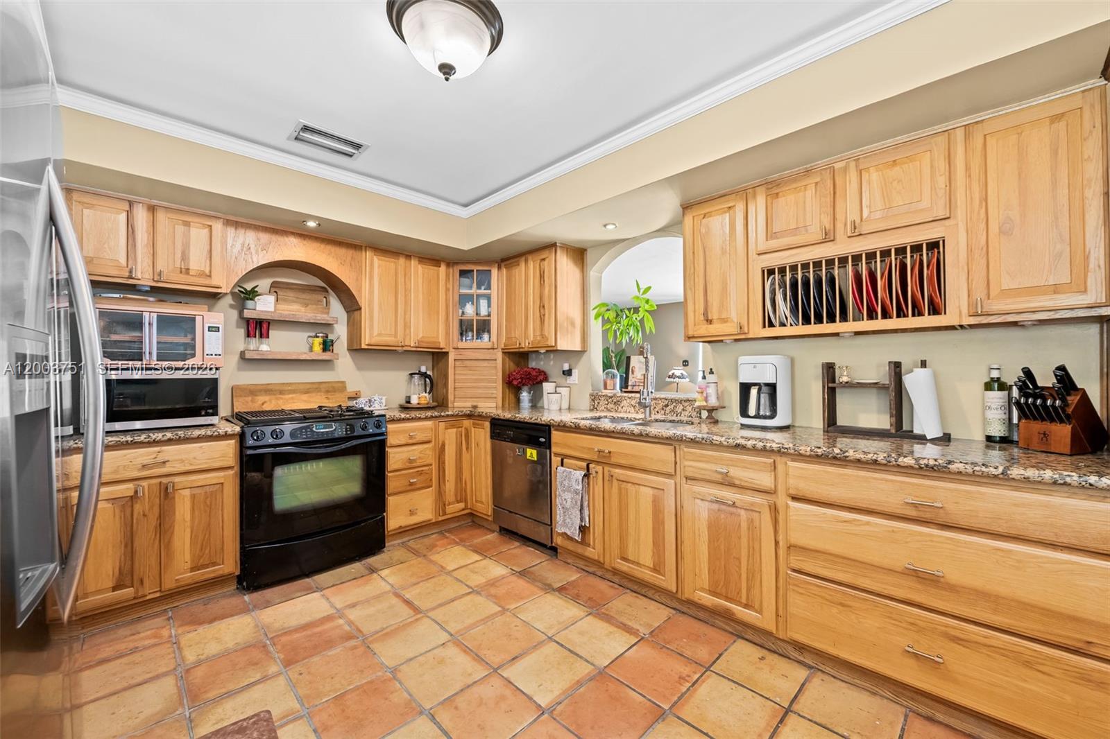 1925 North 39th Avenue Hollywood, FL 33021 - Photo 10 of 20 a kitchen with stainless steel appliances granite countertop a stove sink and cabinets