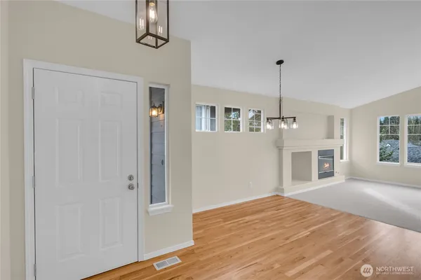 a view of a kitchen with furniture and wooden floor