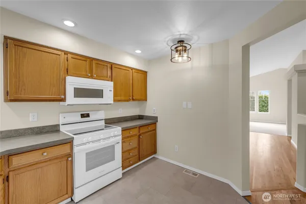 a kitchen with stainless steel appliances a stove microwave and sink