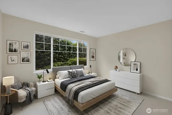 a bedroom with a bed and a large window