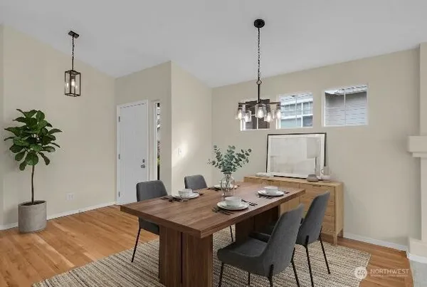 a view of a dining room with a table and chairs