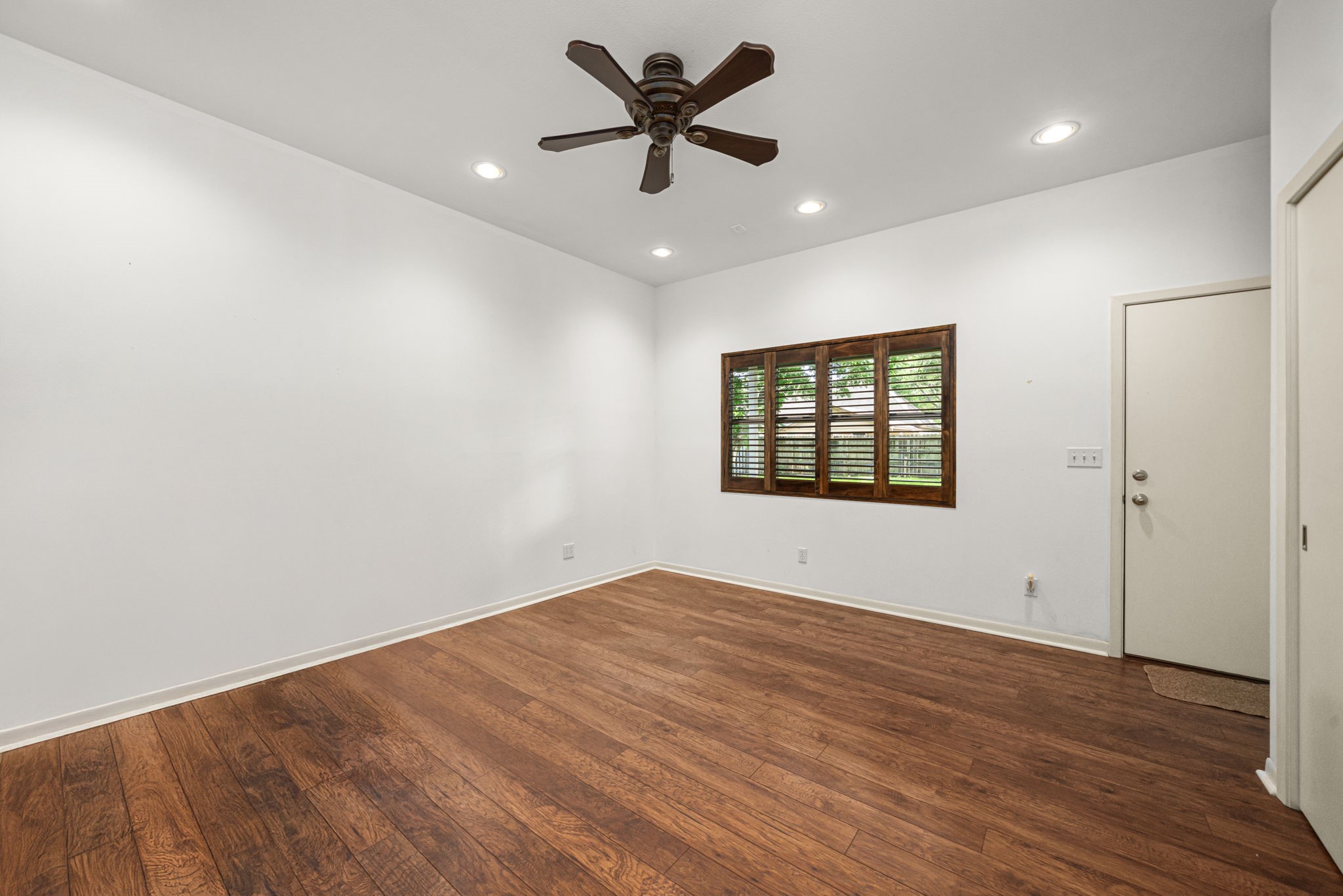 1908 Milam Street Columbus, TX 78934 - Photo 18 of 39 wooden floor in an empty room with a window