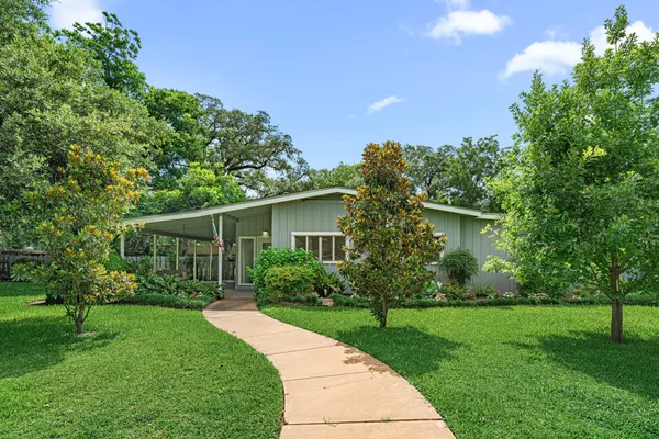 a front view of house with yard and green space