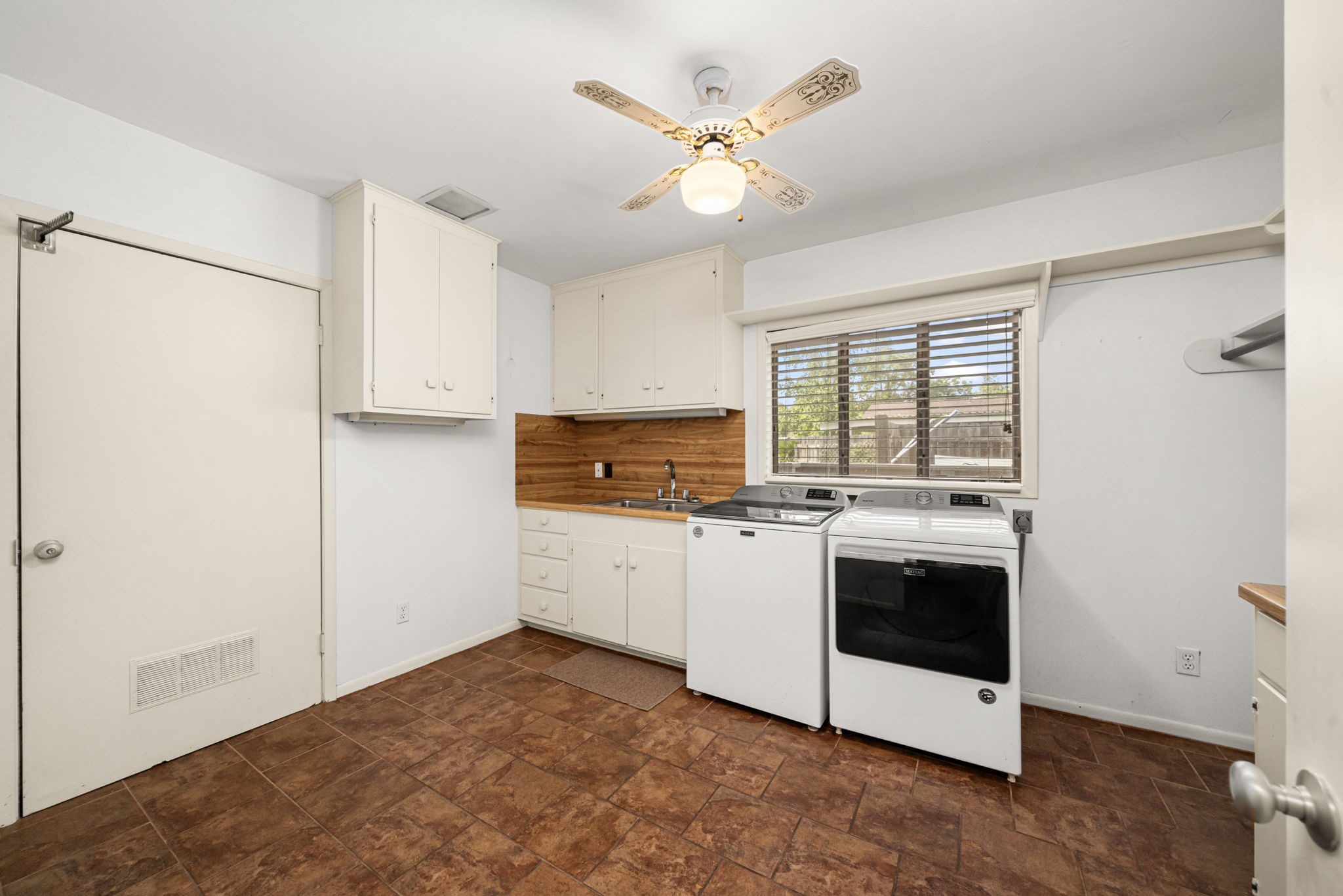 1908 Milam Street Columbus, TX 78934 - Photo 29 of 39 a kitchen with stainless steel appliances granite countertop a stove a refrigerator and a white cabinets