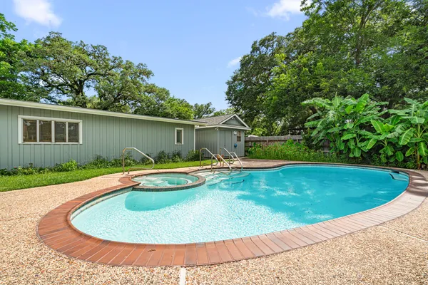 a view of a house with swimming pool and sitting area