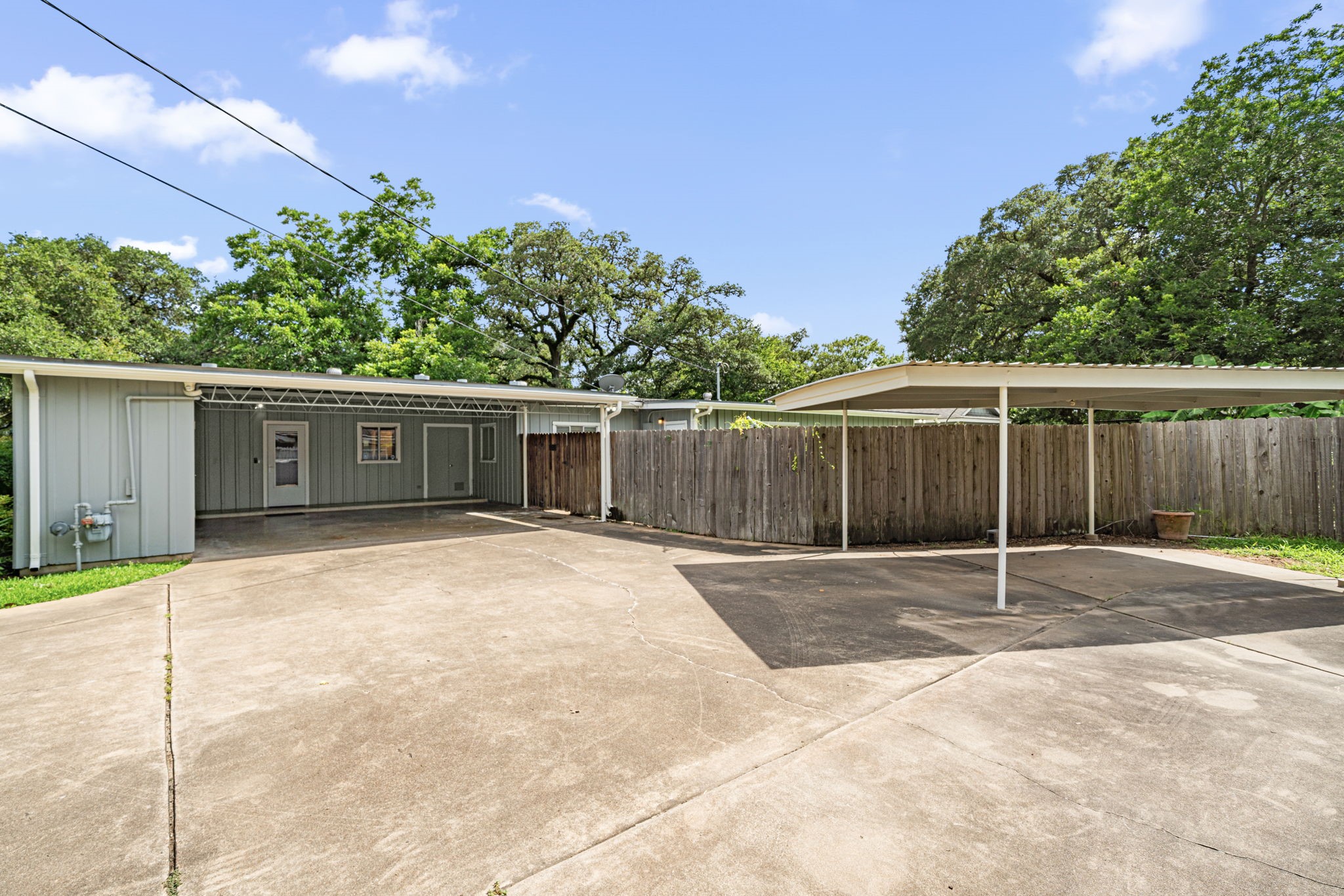 1908 Milam Street Columbus, TX 78934 - Photo 37 of 39 a white house with a small yard and wooden fence