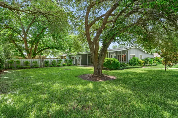 a view of house that has a yard