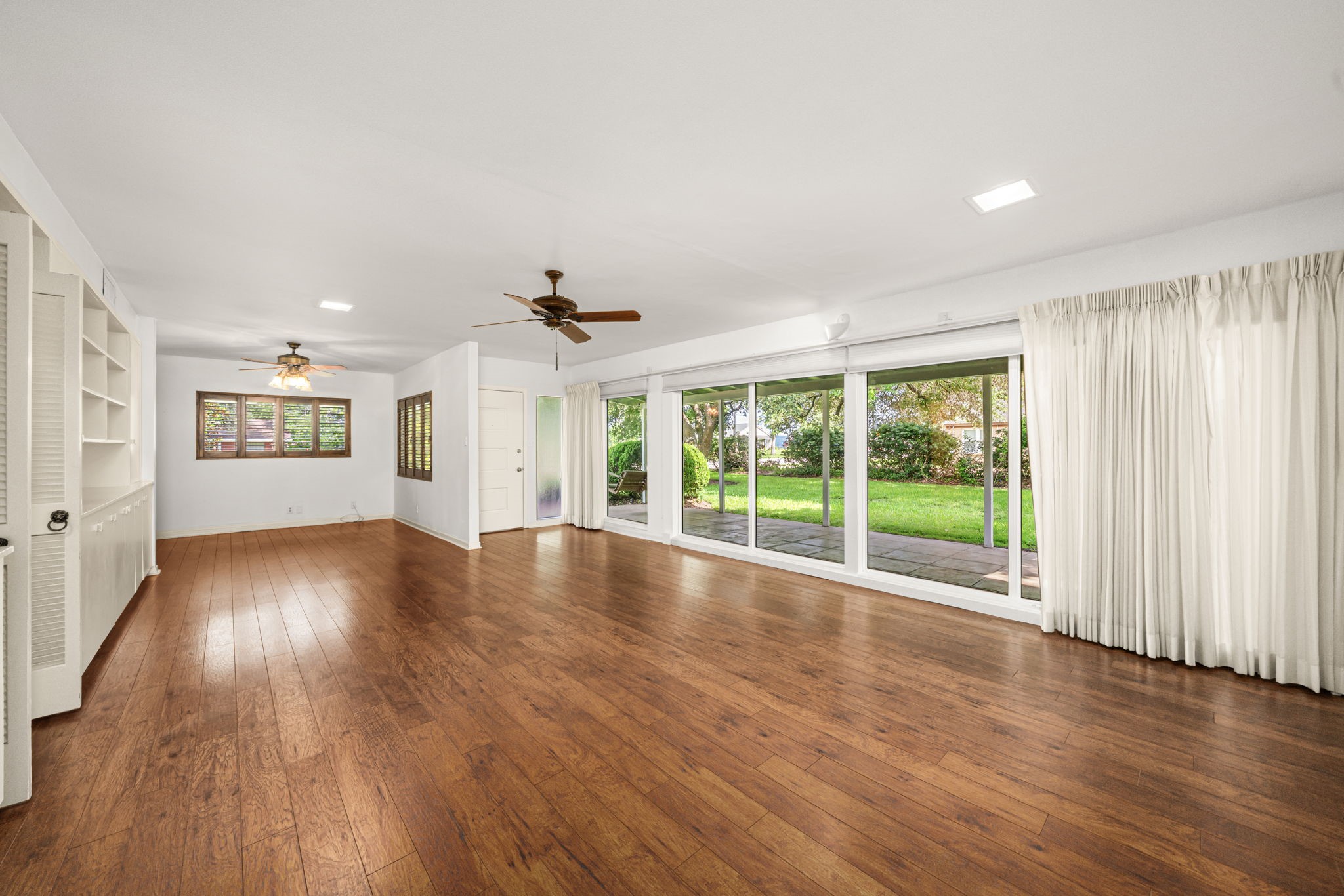 1908 Milam Street Columbus, TX 78934 - Photo 8 of 39 a view of an empty room with wooden floor and a window
