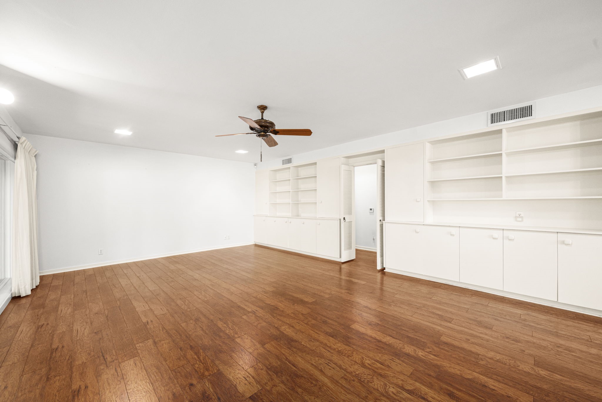 1908 Milam Street Columbus, TX 78934 - Photo 10 of 39 a view of empty room with wooden floor and fan