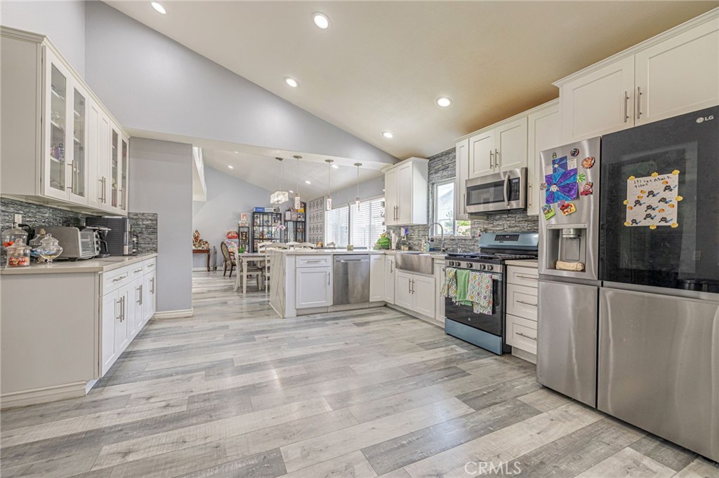 2078 Swindon Avenue Simi Valley, CA 93063 - Photo 11 of 44 a kitchen with stainless steel appliances granite countertop a refrigerator and a stove top oven