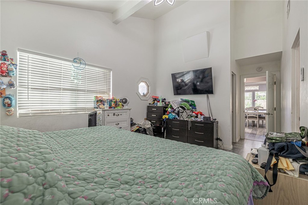 2078 Swindon Avenue Simi Valley, CA 93063 - Photo 21 of 44 a bedroom with a bed and a flat tv screen on dresser