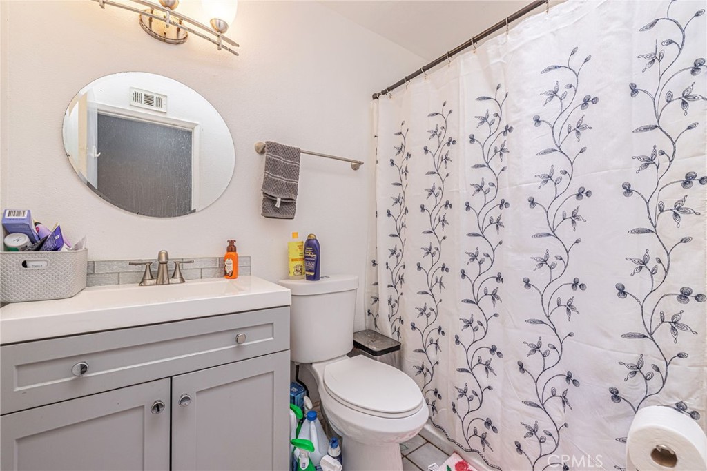 2078 Swindon Avenue Simi Valley, CA 93063 - Photo 28 of 44 a bathroom with a toilet sink and mirror