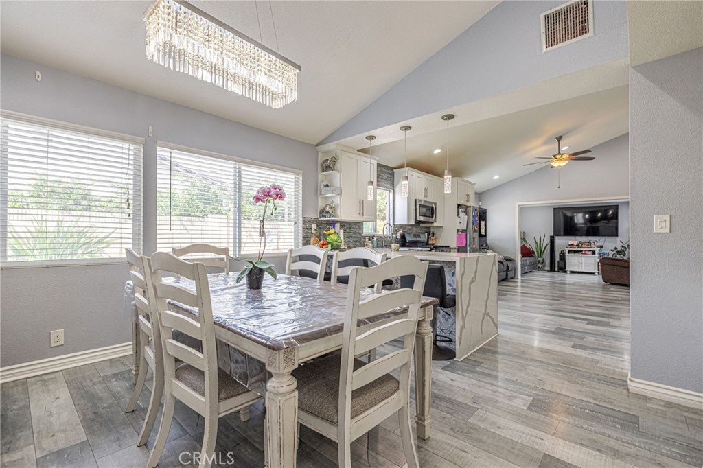 2078 Swindon Avenue Simi Valley, CA 93063 - Photo 7 of 44 a view of a dining room with furniture window and wooden floor