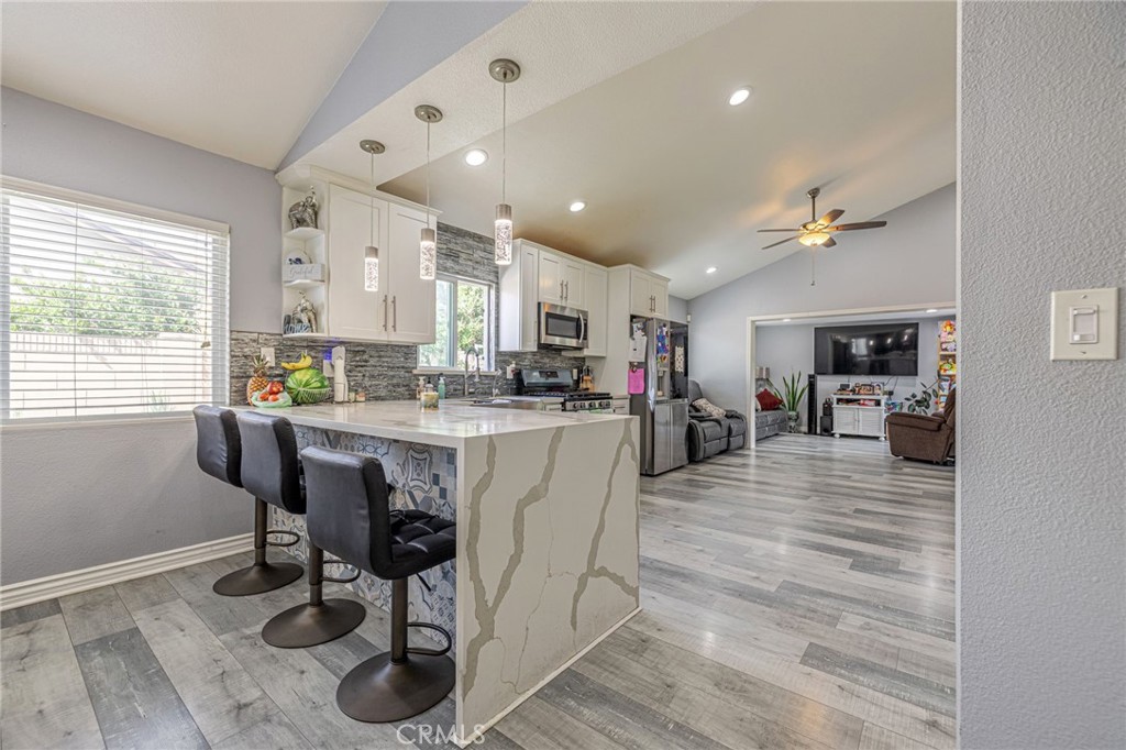 2078 Swindon Avenue Simi Valley, CA 93063 - Photo 9 of 44 a kitchen with a table chairs refrigerator and sink