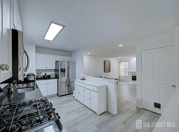 a kitchen with a stove a refrigerator and a stove top oven