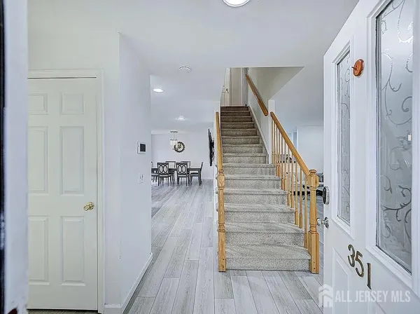 a view of entryway and hall with wooden floor