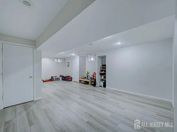 an empty room with wooden floor and gym equipment