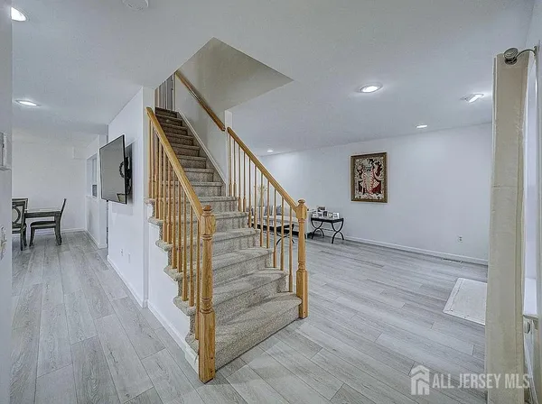 a view of entryway and hall with wooden floor