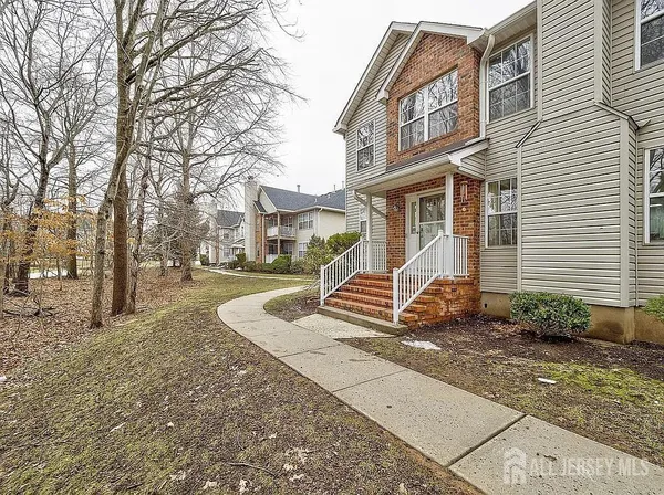 a view of a house with a yard and large trees