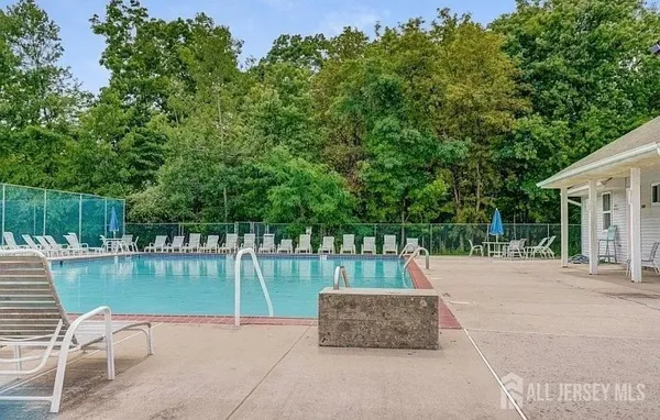 a park view with a bench and trees in the background