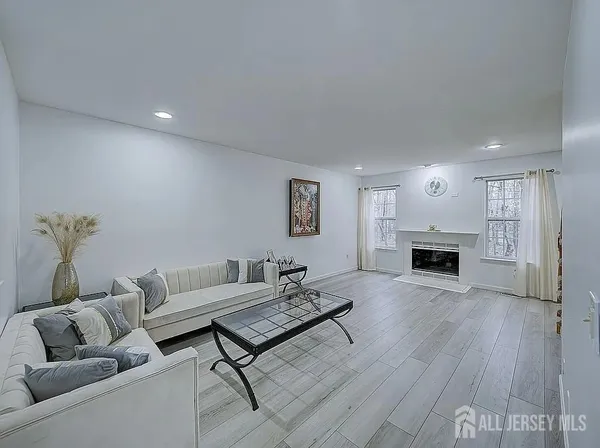 a living room with furniture a fireplace and a chandelier