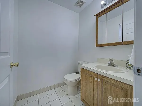 a bathroom with a sink a toilet and mirror