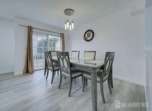 a view of a dining room with furniture a chandelier and wooden floor