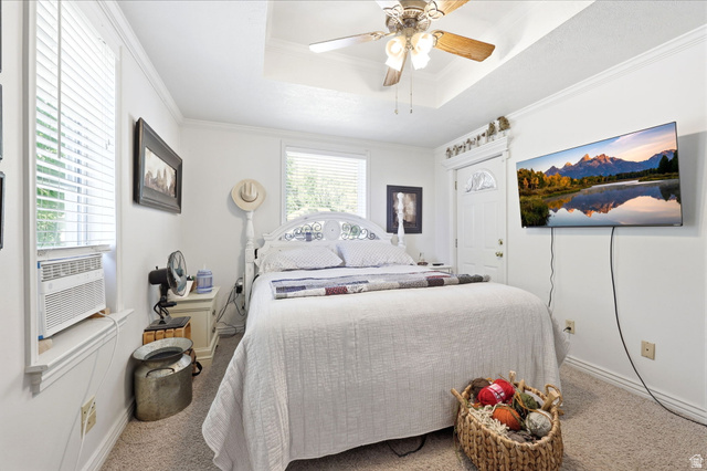 310 South 300 West Payson, UT 84651 - Photo 19 of 42 Bright bedroom featuring two windows with horizontal blinds, a tray ceiling, and a ceiling fan with integrated lighting