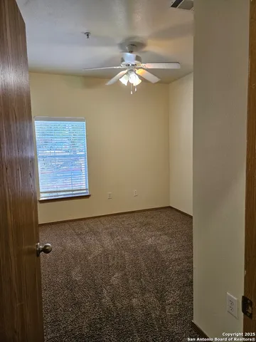 a view of a livingroom with a chandelier fan