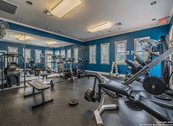 a room with gym equipment and a large window