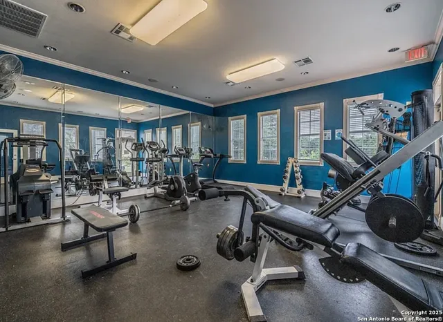 a room with gym equipment and a large window