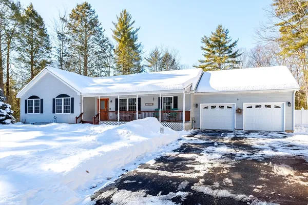 a view of a white house with a yard and large tree