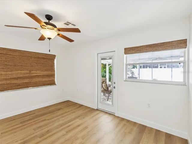 a view of a room with wooden floor and window